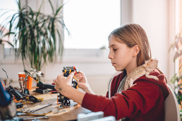 istock Girl building robot 898686996
