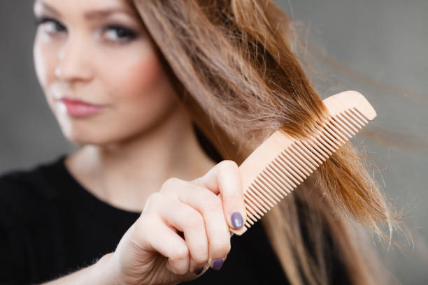istock Long haired girl combing her beauty hair. 898687202