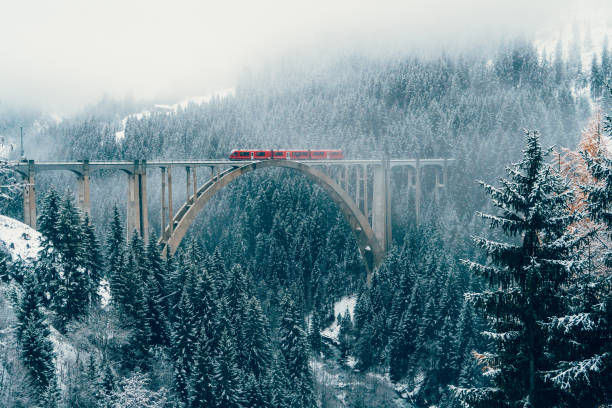 сценический вид поезда на виадук в швейцарии - christmas landscape стоковые фото и изображения