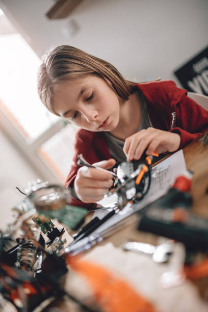 istock Girl building a robot at home 898687538