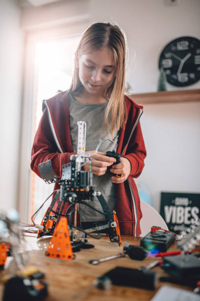 Girl building a robot at home