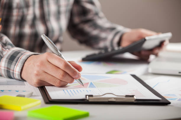 istock Stock market chart and finger pointing on tablet in office. 898692280