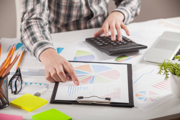 istock Stock market chart and finger pointing on tablet in office. 898692286