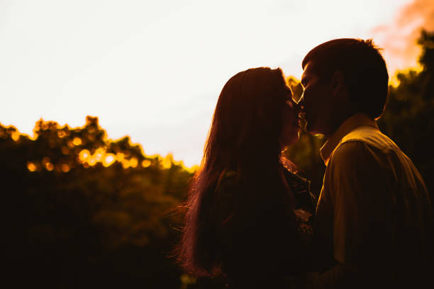 istock Beautiful young couple on the sunset background 898692818