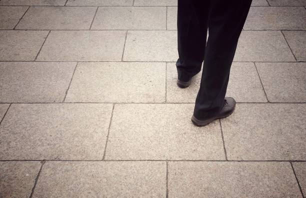 istock Business man standing on concrete floor. 898695202