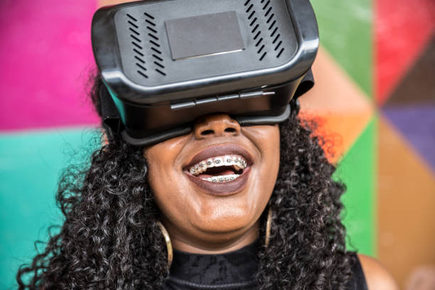 istock African decent woman wearing virtual reality goggles 898695208