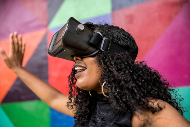istock African decent woman wearing virtual reality goggles 898695222