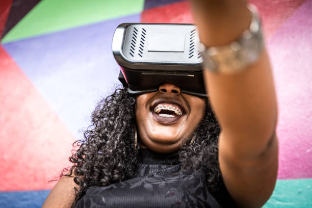 istock African decent woman wearing virtual reality goggles 898695260