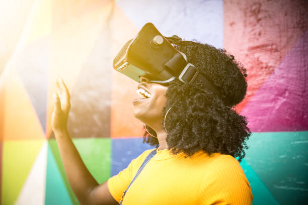istock African decent woman wearing virtual reality goggles 898695268