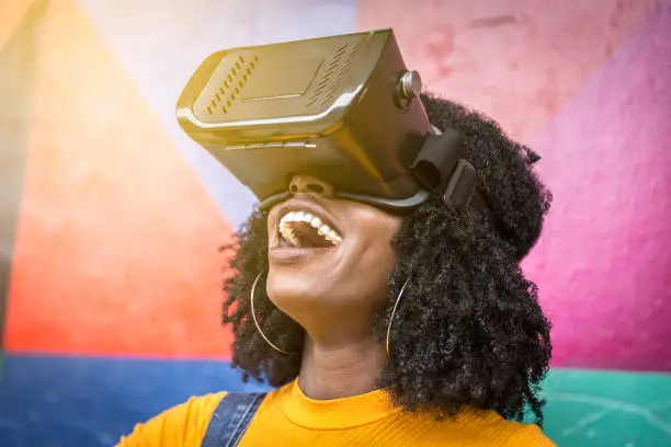 Photo of African decent woman wearing virtual reality goggles