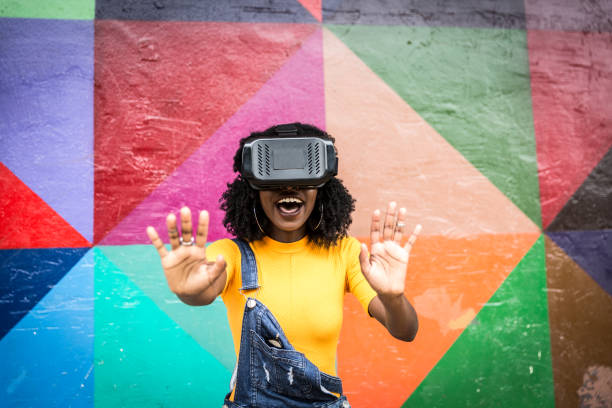 istock African decent woman wearing virtual reality goggles 898695310