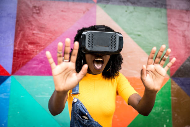 istock African decent woman wearing virtual reality goggles 898695378