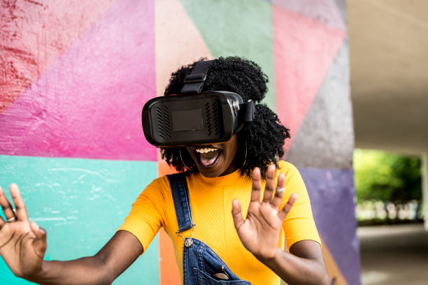 istock African decent woman wearing virtual reality goggles 898695380