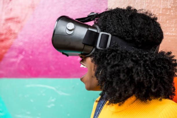 istock African decent woman wearing virtual reality goggles 898695398