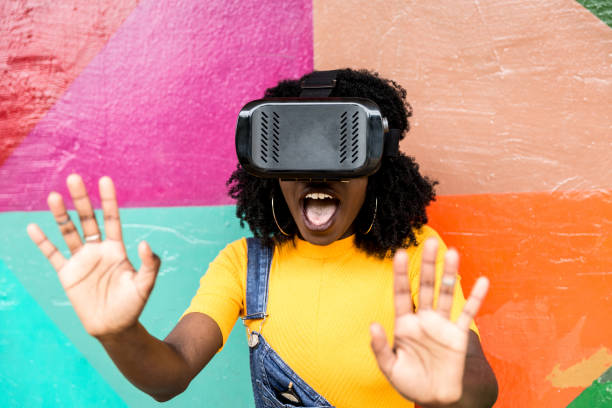 istock African decent woman wearing virtual reality goggles 898695542