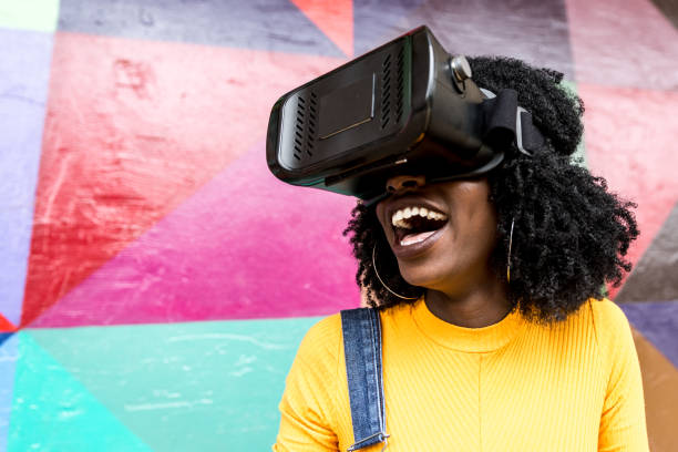 istock African decent woman wearing virtual reality goggles 898695546