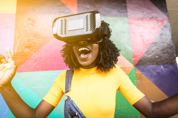 istock African decent woman wearing virtual reality goggles 898695548
