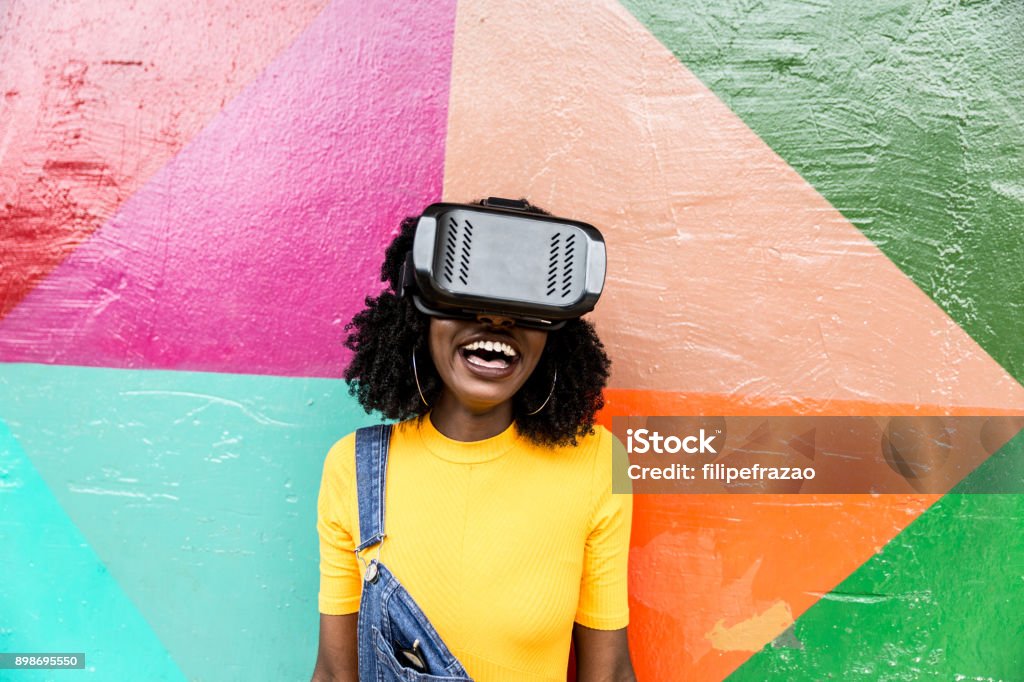 African decent woman wearing virtual reality goggles People collection Virtual Reality Simulator Stock Photo
