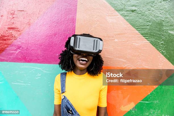 African Decent Woman Wearing Virtual Reality Goggles Stock Photo - Download Image Now