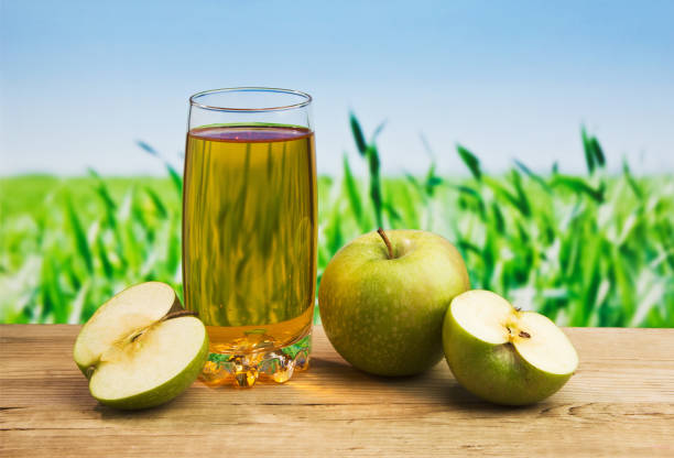 istock Apple juice in a glass on a table 898696064