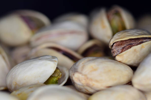 istock Pistachios in the black background 898698824