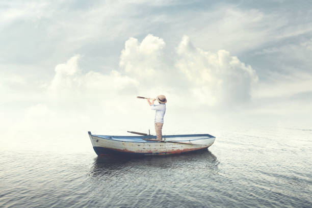 business man on a boat watching the future with a spyglass