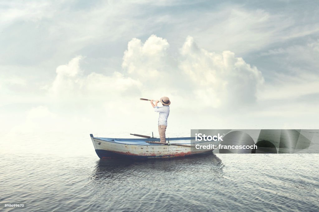 business man on a boat watching the future with binoculars Nautical Vessel Stock Photo