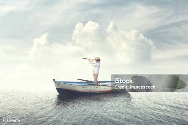 Business Man On A Boat Watching The Future With Binoculars Stock Photo - Download Image Now