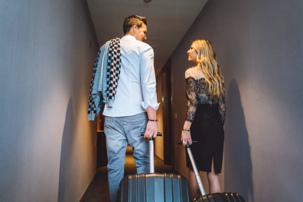 istock Love birds with suitcases going to their hotel suite 898700264