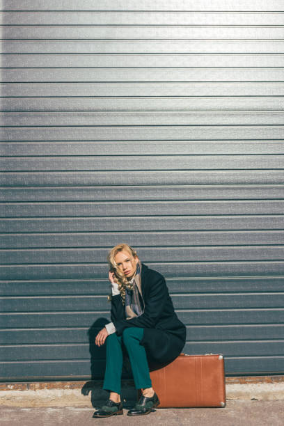 istock young woman with suitcase 898703138