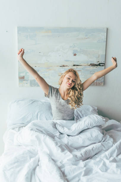 istock young woman in bed 898703384