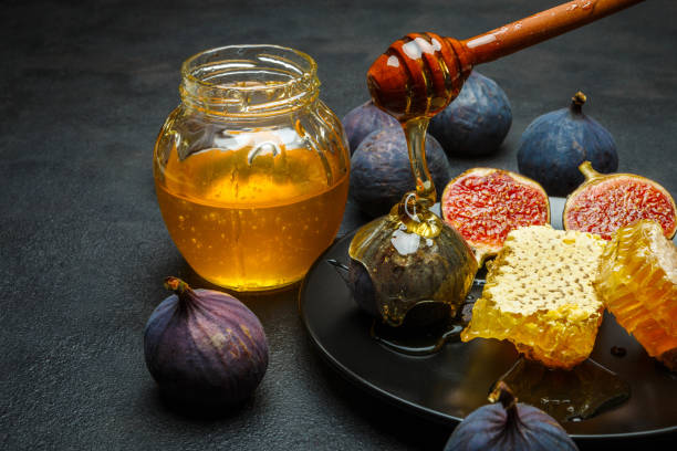 istock Figs with honey on in the plate on dark concrete background 898703738