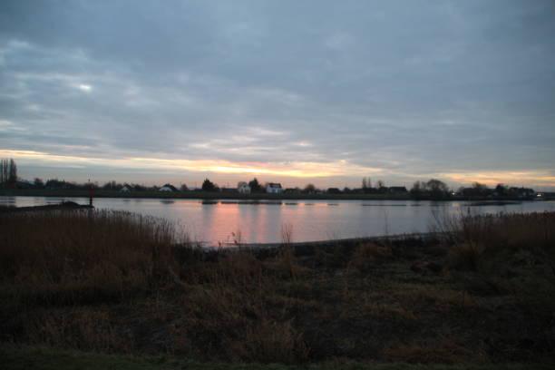 istock Sunrise beams through the couds are reflecting on the river 898704386