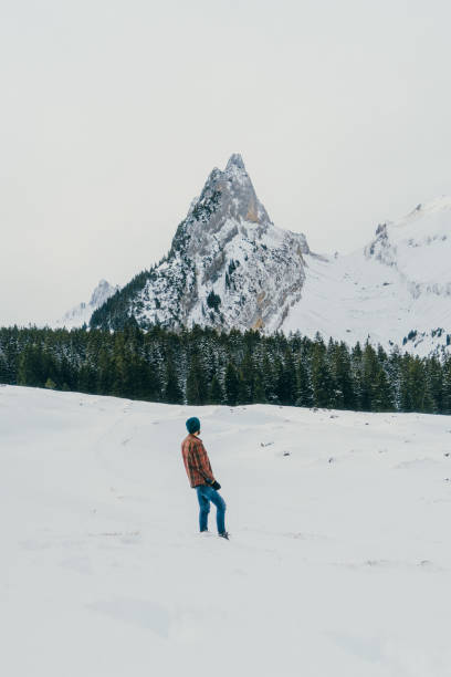 istock Man  walking  on the meadow near the mountains 898706768