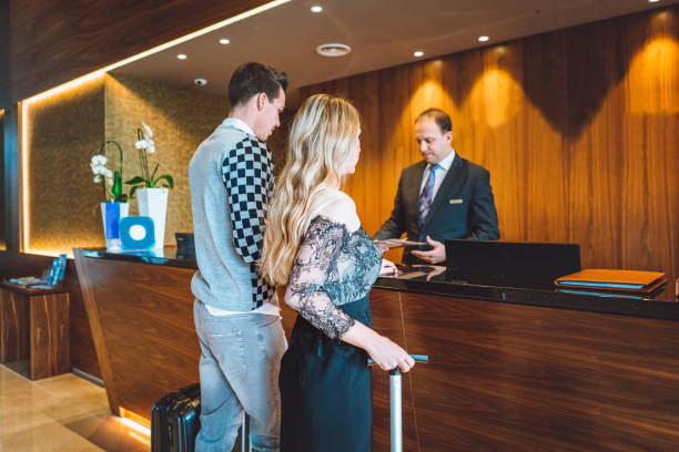 istock Husband and wife at the hotel reception 898706788