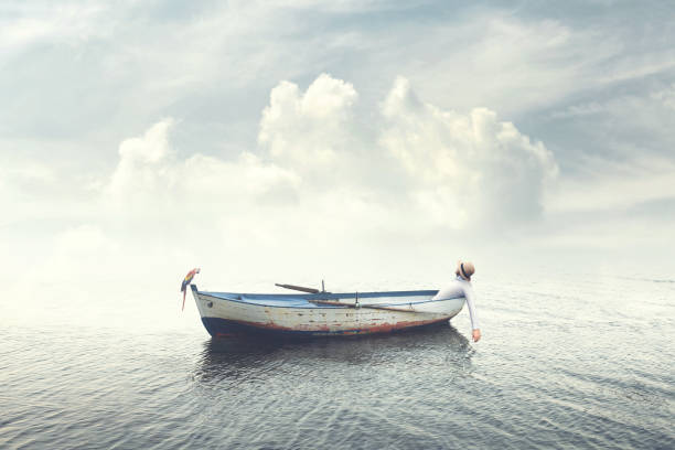 man relaxing on old boat floating in the calm water