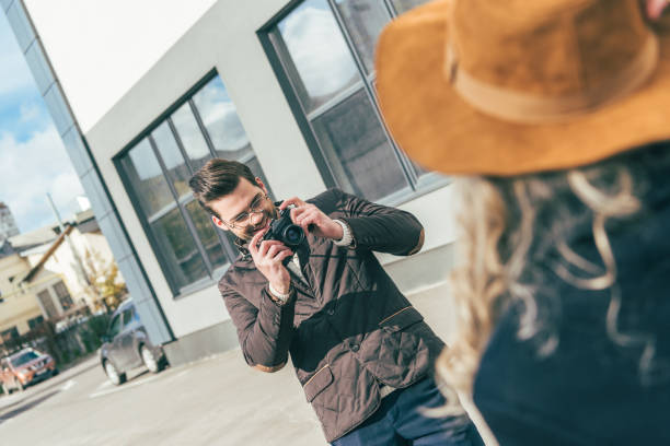 istock man with camera photographing girlfriend 898706978