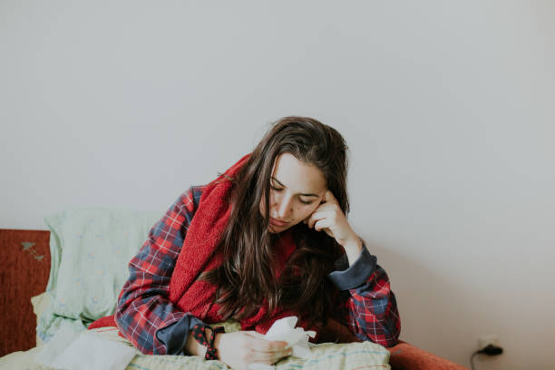 istock Sick woman in bed suffering flu headache 898708100