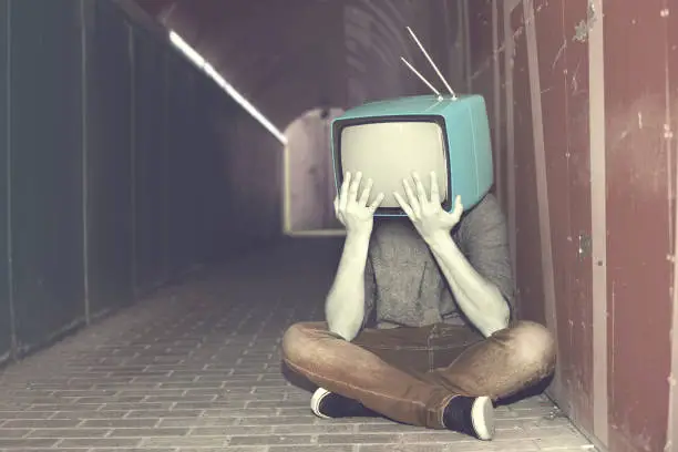 Photo of desperate man with television on his head