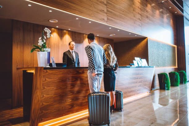 istock Hotel receptionist helping couple with the check-in 898712596