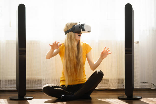 istock Girl wearing virtual reality goggles at home 898715934