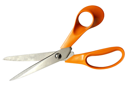Tailoring scissors with orange handles isolated on a white background.