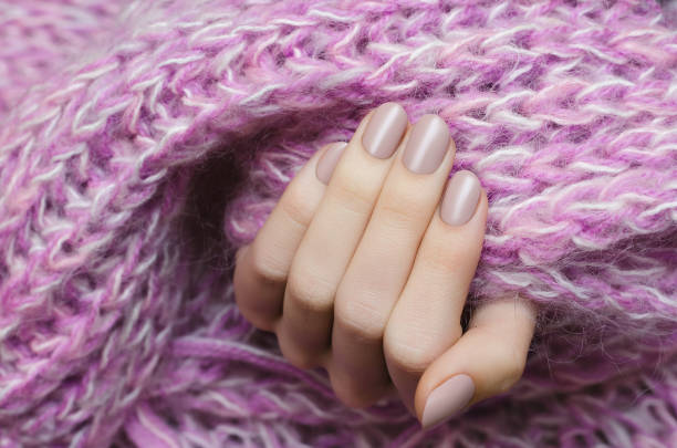 istock Beautiful female hand with beige manicure. 898720256