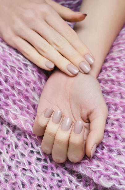 istock Beautiful female hand with beige manicure 898720298