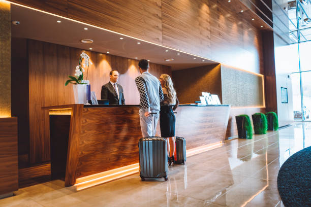 istock Young married couple arriving at a hotel lobby 898720378