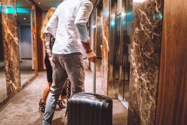 istock Young married couple arriving at hotel 898720482
