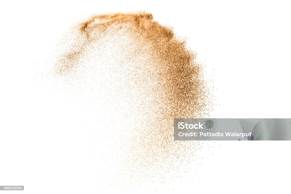 Gold sand explosion isolated on white background. Abstract sand cloud. Gold sand splash against on clear background. Sandy fly wave in the air. Sand Stock Photo