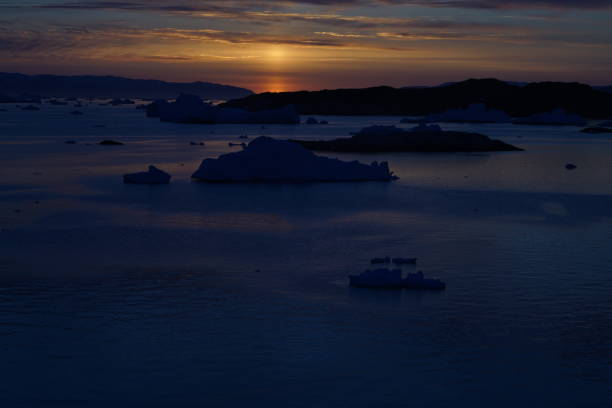 Sunset on Arctic Icebergs on Arctic Ocean in Greenland