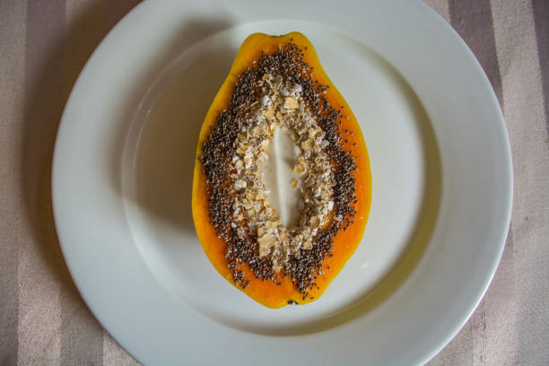 Papaya with chia seeds, oats and yogurt for breakfast