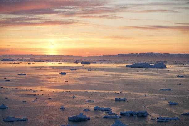 istock Sunset on Arctic Icebergs on Arctic Ocean in Greenland 898727496